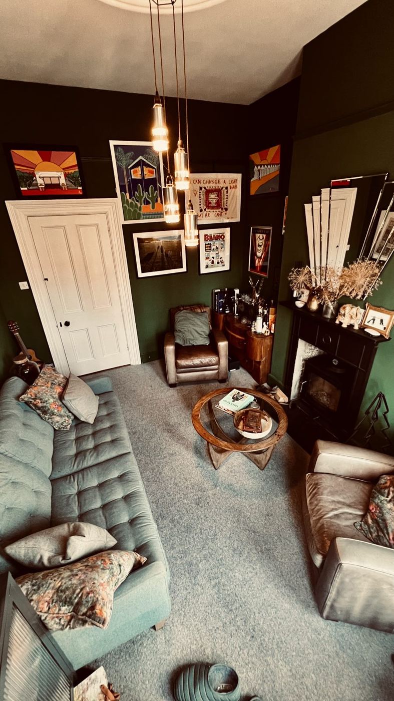 The whisky room, with sofa, armchairs and log burner